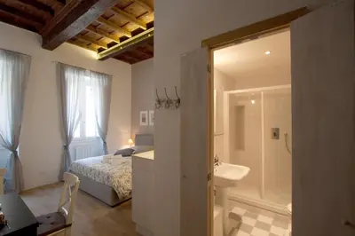 a bedroom with a bed and a bathroom with a shower at Apartment Ripa 17 in Rome