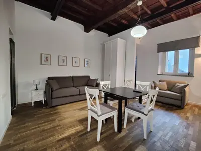 a living room with a table and chairs and a couch at Apartment Ripa 17 in Rome