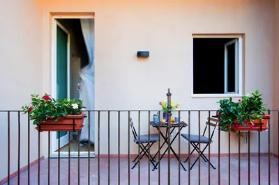 a table and chairs on a balcony with plants at Apartment Ripa 17 in Rome