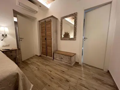 a bedroom with a bed and a mirror on the wall at ARTPA Rome Apartments Trastevere Mameli, Roma in Rome