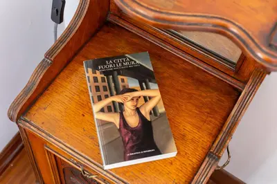 a magazine sitting on top of a wooden table at iFlat The Roman House - Spacious & Central Apt in Rome