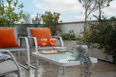 a patio with two wine glasses on a table at Terrazza d'autore in Rome
