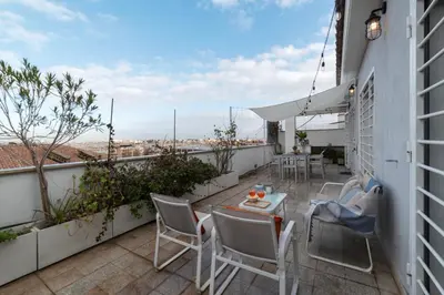 a patio with chairs and a table on a balcony at Terrazza d'autore in Rome