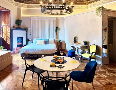 a hotel room with a bed and a table and chairs at Z-ArchSuites URBE in Rome