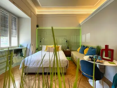 a bedroom with a bed and a table and a couch at Z-ArchSuites URBE in Rome