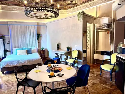 a hotel room with a bed and a table and chairs at Z-ArchSuites URBE in Rome