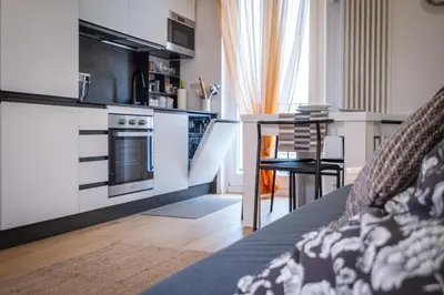 a kitchen with a stove and a table in a room at ht siesta sistina in Rome