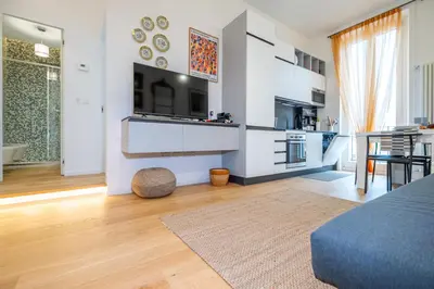 a living room with a kitchen and a dining room at ht siesta sistina in Rome