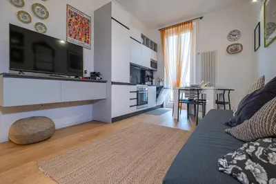 a living room with a couch and a tv at ht siesta sistina in Rome