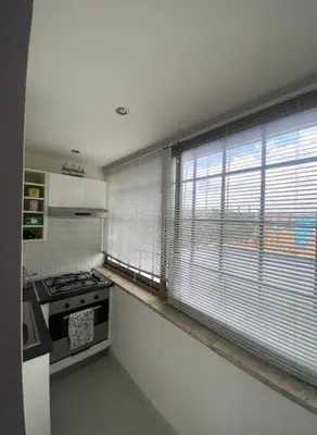 a kitchen with a stove and a window at Attico Porta Furba Rome in Rome