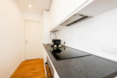a kitchen with a black counter top in a room at Casanuova in Rome
