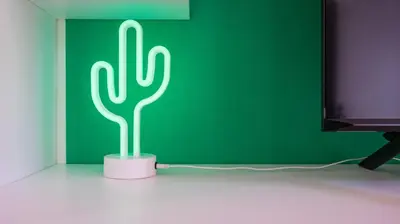 a green neon cactus lamp in front of a green wall at Villa Paolina by Rentbeat in Rome