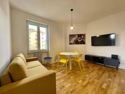 a living room with a couch and a table at Metro Marconi - University quarter apartments in Rome