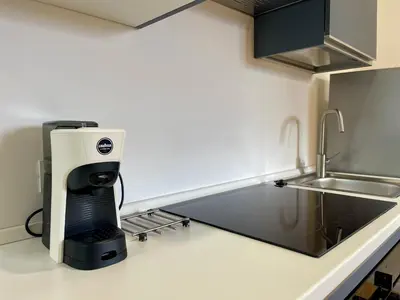 a coffee maker on a counter in a kitchen at Metro Marconi - University quarter apartments in Rome