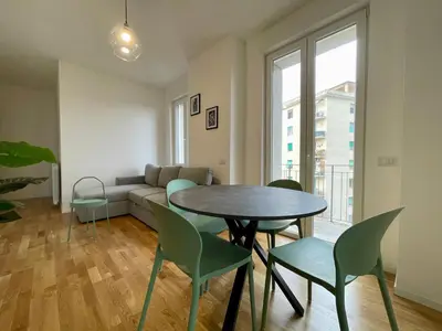 a living room with a table and chairs and a couch at Metro Marconi - University quarter apartments in Rome