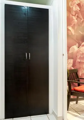 a black cabinet with black doors in a room at Plumeria Bianca in Rome