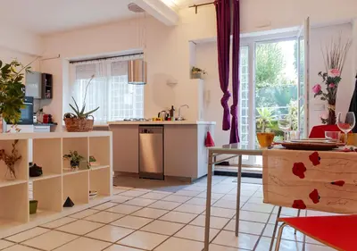 a kitchen with a table and a counter top at Plumeria Bianca in Rome