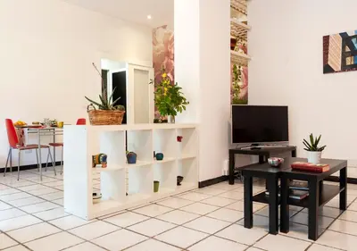 a living room with a table and a tv at Plumeria Bianca in Rome