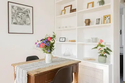 a dining room with a table with flowers on it at Governo Central Apartment in Rome