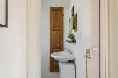 a bathroom with a sink and a toilet at Governo Central Apartment in Rome