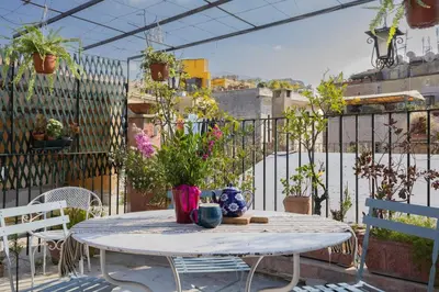 a table with a vase on it on a patio at Governo Central Apartment in Rome