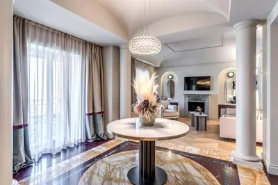 a living room with a table and a fireplace at Dimora Coppelle - Adults Only in Rome