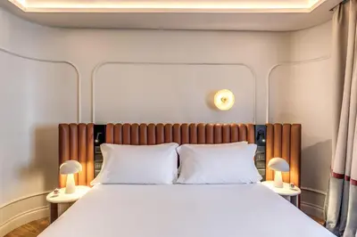 a bedroom with a large bed with two lamps at Dimora Coppelle - Adults Only in Rome