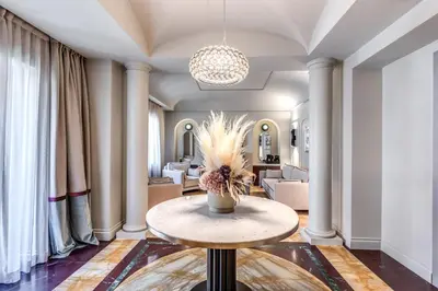 a room with a table with a vase of flowers on it at Dimora Coppelle - Adults Only in Rome