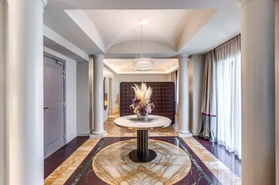 a living room with a table in the middle at Dimora Coppelle - Adults Only in Rome