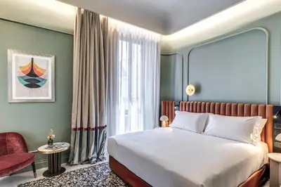 a hotel room with a bed and a window at Dimora Coppelle - Adults Only in Rome