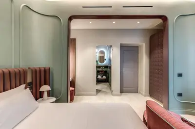 a bedroom with a bed and a mirror at Dimora Coppelle - Adults Only in Rome