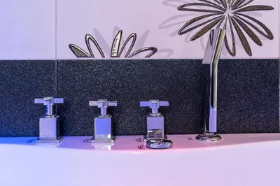 a bathroom with four soap bottles on a sink at Stella su San Pietro in Rome