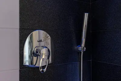 a mirror on the wall of a shower in a bathroom at Stella su San Pietro in Rome