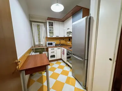a kitchen with a stainless steel refrigerator and a checkered floor at Susy's Lovely Flat near Trastevere in Rome