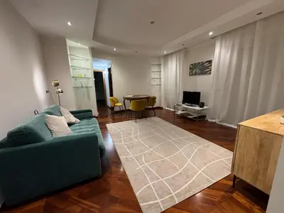 a living room with a green couch and a table at Susy's Lovely Flat near Trastevere in Rome