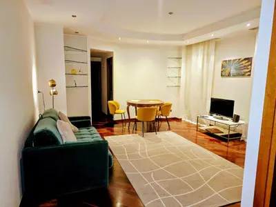 a living room with a green couch and a table at Susy's Lovely Flat near Trastevere in Rome