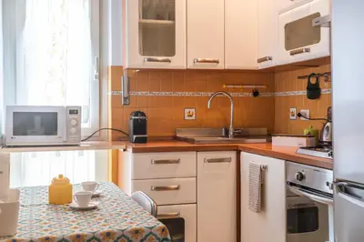 a kitchen with a table and a microwave at Susy's Lovely Flat near Trastevere in Rome