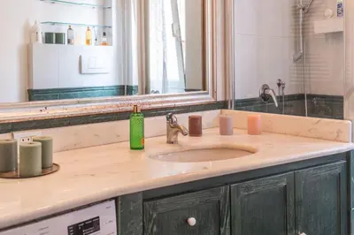 a bathroom counter with a sink and a mirror at Susy's Lovely Flat near Trastevere in Rome