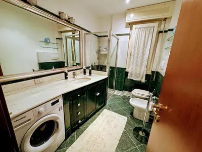 a bathroom with a sink and a washing machine at Susy's Lovely Flat near Trastevere in Rome