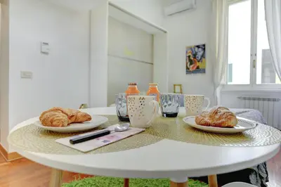 a white table with two plates of pastries on it at Colosseo - MecenStudio - Home and More in Rome