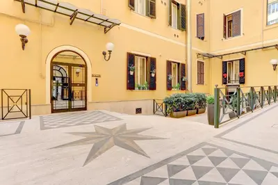 a building with a star on the ground in a courtyard at Colosseo - MecenStudio - Home and More in Rome