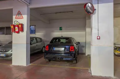 a parking garage with a car parked in it at Vatican Exclusive Penthouse w Terrace and Parking in Rome