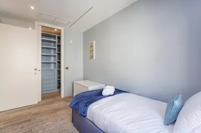 a small bedroom with a bed and a closet at Vatican Exclusive Penthouse w Terrace and Parking in Rome