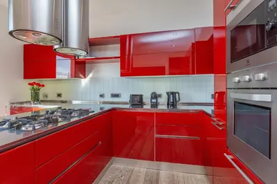 a red kitchen with red cabinets and a stove at Vatican Exclusive Penthouse w Terrace and Parking in Rome