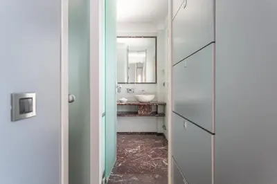 a bathroom with a sink and a mirror at Vatican Exclusive Penthouse w Terrace and Parking in Rome