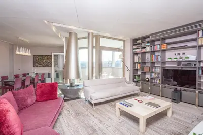 a living room with a couch and a table at Vatican Exclusive Penthouse w Terrace and Parking in Rome
