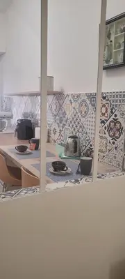 a kitchen with a counter and a tile wall at A casa di Fede b&b in Rome