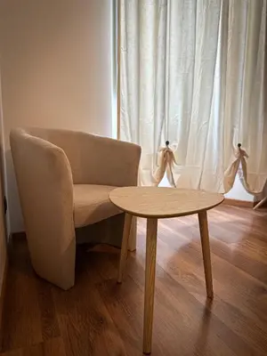 a living room with a chair and a table at Dreamingrome in Rome