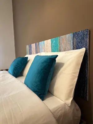 a bed with two blue pillows on top of it at Dreamingrome in Rome