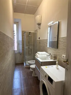 a bathroom with a shower sink and a toilet at Dreamingrome in Rome